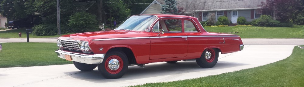 1962 Plymouth Belvedere four-door sedan finished in white with red interior